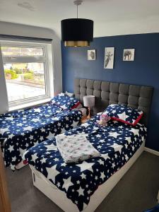 a bedroom with two twin beds and a window at Modern family home central Cheltenham in Cheltenham