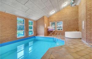 una gran piscina en una habitación con bañera en Cozy Home In Hirtshals With Kitchen, en Hirtshals