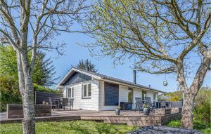 a white cottage with a deck and patio at Lovely Home In Struer With Kitchen in Struer