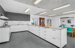 a large white kitchen with white cabinets and a table at Stunning Home In Hanstholm With Sauna in Hanstholm