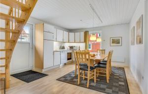 a kitchen and dining room with a table and chairs at Marina Fiskenæs Feriepark in Gråsten