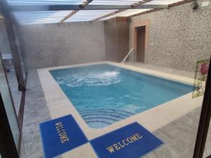 ein Schwimmbad in einem Gebäude mit Schildern darauf in der Unterkunft Casa Rural Abuela Consuelo Estudio La Adobera in San Pascual + 7 Fotos