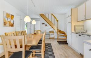 a kitchen and dining room with a table and chairs at Marina Fiskenæs Feriepark in Gråsten +21 photos