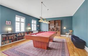 a living room with a pool table in the middle at Rimersgaard in Horslunde