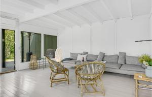 a living room with a couch and chairs and a table at Four-Bedroom Holiday Home In Tisvildeleje in Tisvildeleje
