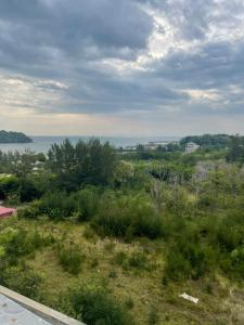 a view of a field with the ocean in the background at Private Condo Port Dickson Waterfront in Port Dickson