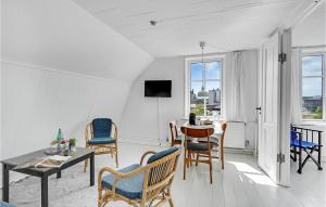 a living room with a table and chairs at Beautiful Apartment In Svendborg With House Sea View in Svendborg