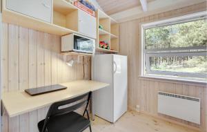 a small kitchen with a desk and a refrigerator at Godt Gemt in Vester Sømarken