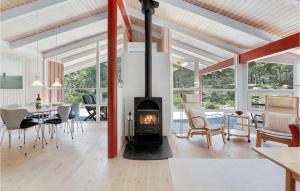 a living room with a fireplace and a dining room at Godt Gemt in Vester Sømarken