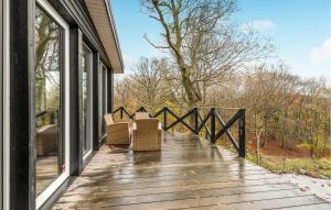 a deck with two chairs on a house at Awesome Home In Gistrup With Sauna, Wifi And 3 Bedrooms in Gistrup