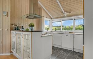 a kitchen with white cabinets and a window at 4 Bedroom Gorgeous Home In Børkop in Børkop