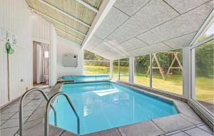 エーベルトフトにあるAwesome Home In Ebeltoft With Sauna, Wifi And Indoor Swimming Poolの大きな窓のある家の中のスイミングプール