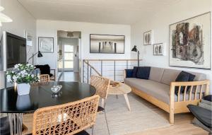 a living room with a couch and a table at 2 Bedroom Stunning Apartment In Allinge in Allinge