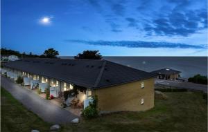 a house with a black roof with the moon in the sky at 2 Bedroom Stunning Apartment In Allinge in Allinge