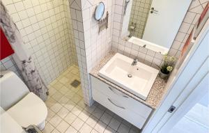 a bathroom with a sink and a toilet at 2 Bedroom Stunning Apartment In Allinge in Allinge