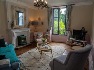 sala de estar con sofá y chimenea en Chez Dizjon, A Stunning Canalside Property, en Josselin