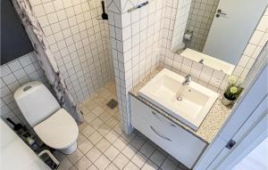 a white bathroom with a sink and a toilet at 2 Bedroom Stunning Apartment In Allinge in Allinge