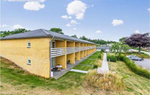 a brick building with a walkway next to a road at 2 Bedroom Stunning Apartment In Allinge in Allinge