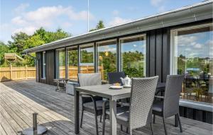 a patio with a table and chairs on a deck at Two-Bedroom Holiday Home In Ebeltoft in Ebeltoft