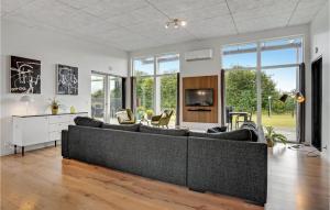 a living room with a couch and a tv at Four-Bedroom Holiday Home Haderslev With A Room Hot Tub 08 in Knud