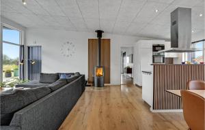 a living room with a couch and a kitchen at Four-Bedroom Holiday Home Haderslev With A Room Hot Tub 08 in Knud