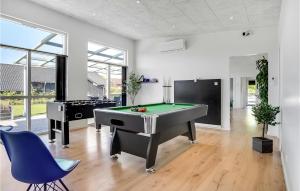 a living room with a pool table and a piano at Four-Bedroom Holiday Home In Haderslev in Haderslev