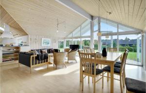 a dining room and living room with a table and chairs at Awesome Home In Stege With Sauna in Stege