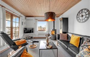 a living room with a couch and a table at Stunning Home In Hejls With Sauna in Hejls