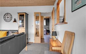 a living room with a couch and a table at Stunning Home In Hejls With Sauna in Hejls
