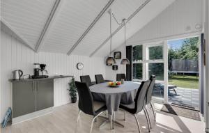 a kitchen and dining room with a table and chairs at Holiday Home Søknudevej Ansager Denm in Ansager