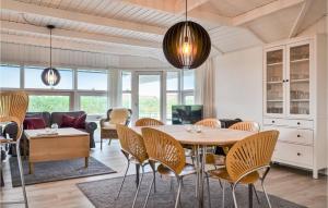 a dining room with a table and chairs at Stunning Home In Hvide Sande With Wifi in Bjerregård