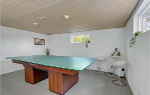 a ping pong table in the middle of a room at Holiday Home Teglager K-674 in Hejls