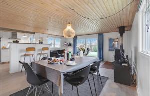 a kitchen and dining room with a table and chairs at Holiday Home Egemose Sydals Denm in Skovby
