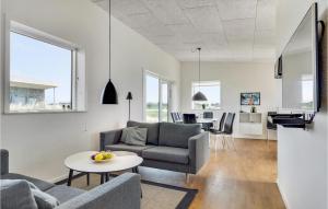a living room with a couch and a table at Gorgeous Home In Ringkbing With House A Panoramic View in Søndervig