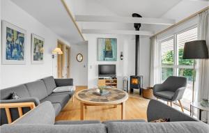 a living room with a couch and a table at Gorgeous Home In Hejls With Kitchen in Hejls