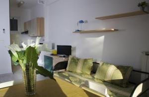 a living room with a vase of flowers on a table at Residence Costa Templada in Ventimiglia