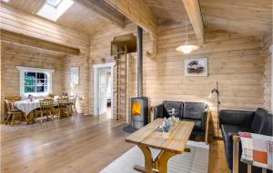 a living room with a fireplace and a table at Holiday Home Holmegårdsvej Rønne V in Hasle