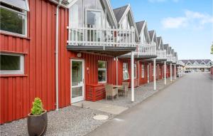 een rij rode gebouwen met witte balkons erop bij Awesome Home In Hasle With Harbor View in Hasle