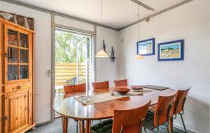 a dining room with a wooden table and chairs at 3 Bedroom Nice Home In Nex in Balke