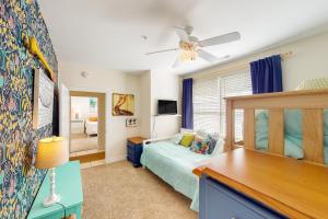a bedroom with a bed and a desk at The Sandbridge Dunes - A Beach Delight 116 in Virginia Beach