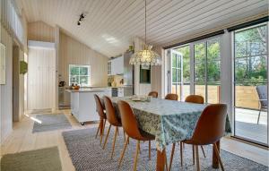a kitchen and dining room with a table and chairs at Beach Front Home In Stege With Wifi in Stege