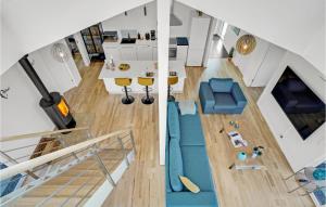 an overhead view of a living room and kitchen with a staircase at Holiday Home Brombærvej Skjern Xii in Lem +24 photos
