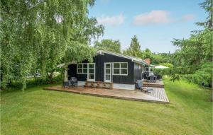 a small black house with a wooden deck at Pet Friendly Home In Stege With Wifi in Stege