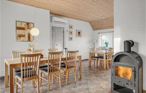 a kitchen and dining room with a wood stove at Stunning Home In Skjern With Kitchen in Lem