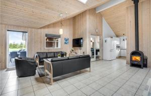 een woonkamer met een bank en een open haard bij Stunning Home In Idestrup With Indoor Swimming Pool in Bøtø By