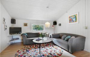 a living room with two couches and a table at Amazing Home In Herning With Kitchen in Kølkær