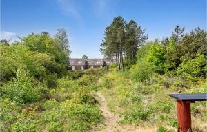 a dirt trail leading to a building in the woods at 2 Bedroom Nice Home In Rm in Rømø Kirkeby