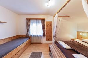 - une chambre avec 2 lits et une fenêtre dans l'établissement Florerhof Ferienwohnung Lavendel, à Vols am Schlern