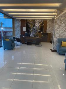 a lobby with blue couches and a stone wall at بيست تريب فالنسيا in Jazan