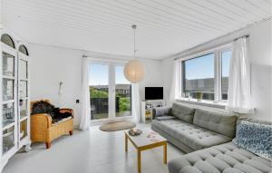 ThorsmindeにあるNice Home In Ulfborg With House A Panoramic Viewのリビングルーム(ソファ付)が備わります。一部の窓があります。